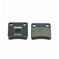 Two Precision Brake Pads for KR Cadet Kart Brake System, One showing the branded back and the other the textured friction surface